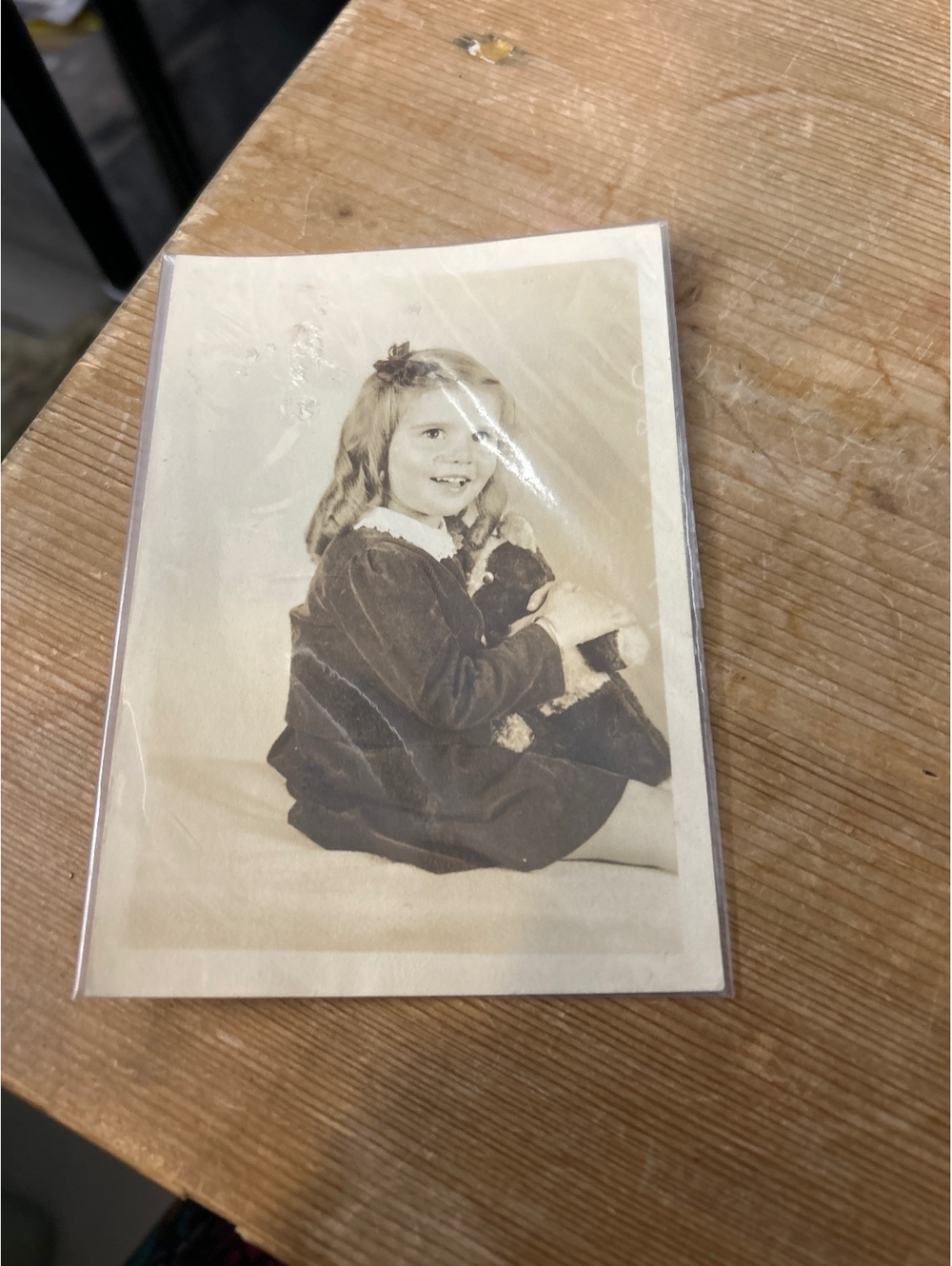Vintage photo of a child with a teddy bear